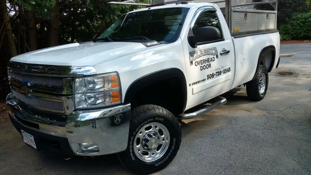 White Chevrolet pickup lettered Classic Overhead Door with the 508-726-2545 phone number on the door